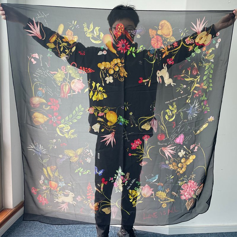 a man is hanging a 140x140cm scarf