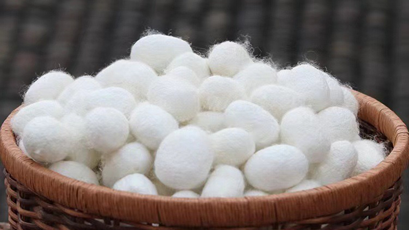 a basket overflowing with soft white cocoons, inviting warmth and comfort.