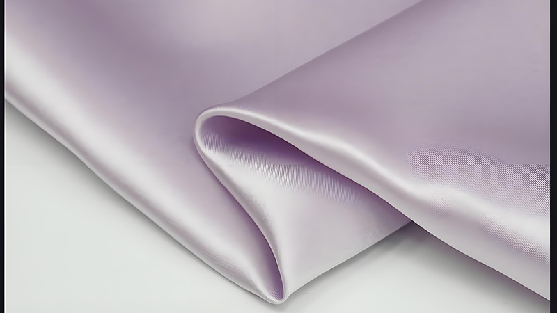 a close up view of luxurious purple satin silk fabric, showcasing its smooth texture and rich color.