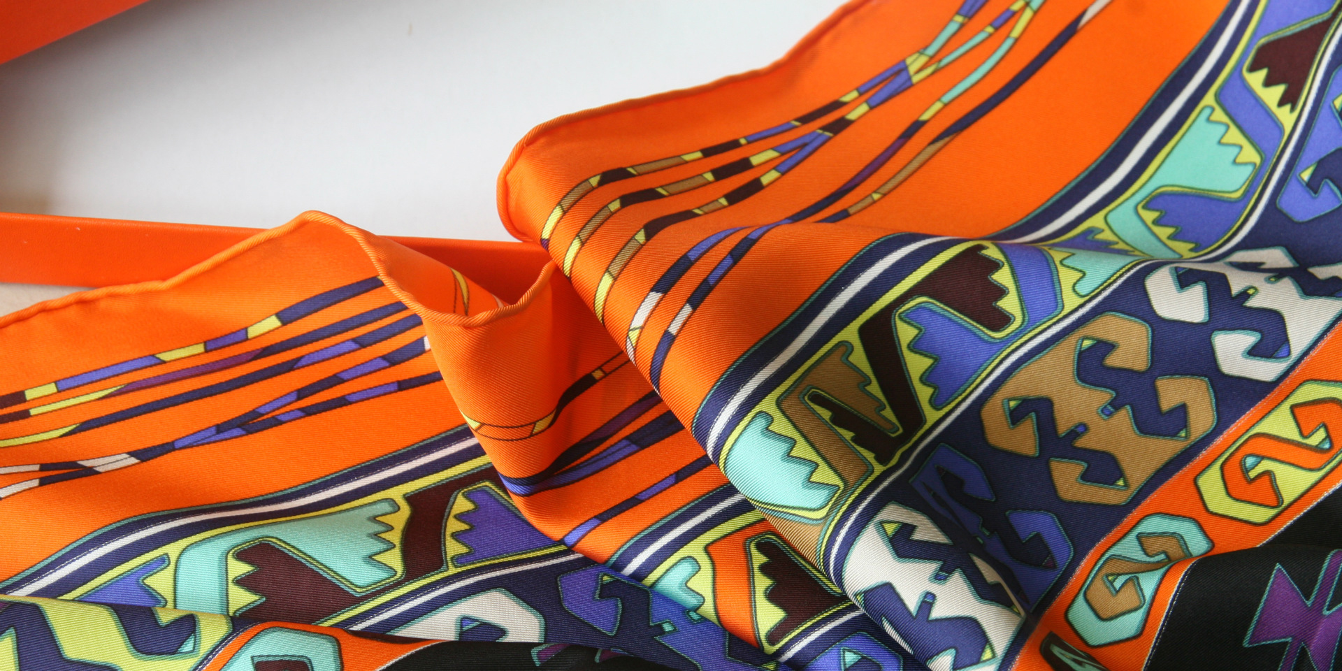 a close up view of various colored scrunchies arranged together, showcasing their vibrant hues and textures